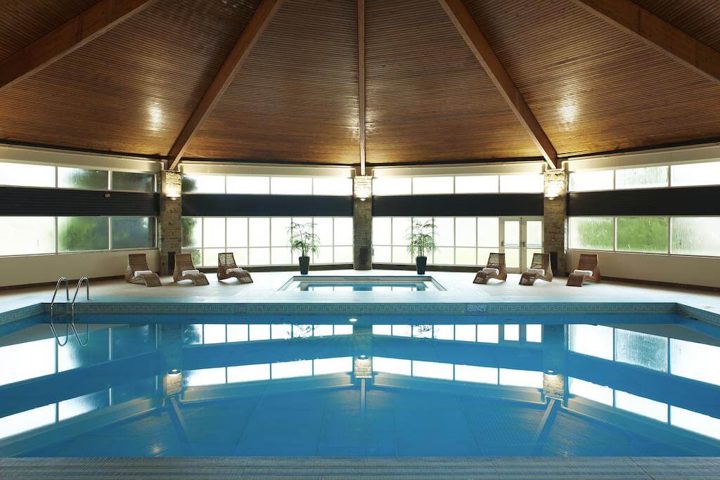 Indoor heated swimming pool at St Pierre Marriott Hotel and Country Club with loungers