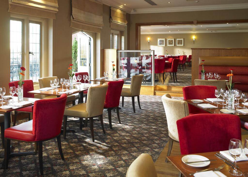 Restaurant with tables set for guests at Hanbury Manor Golf Marriott Hotel And Country Club