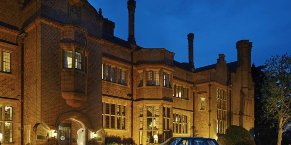 Exterior view of the entrance at Hanbury Manor Golf Marriott Hotel And Country Club in the evening