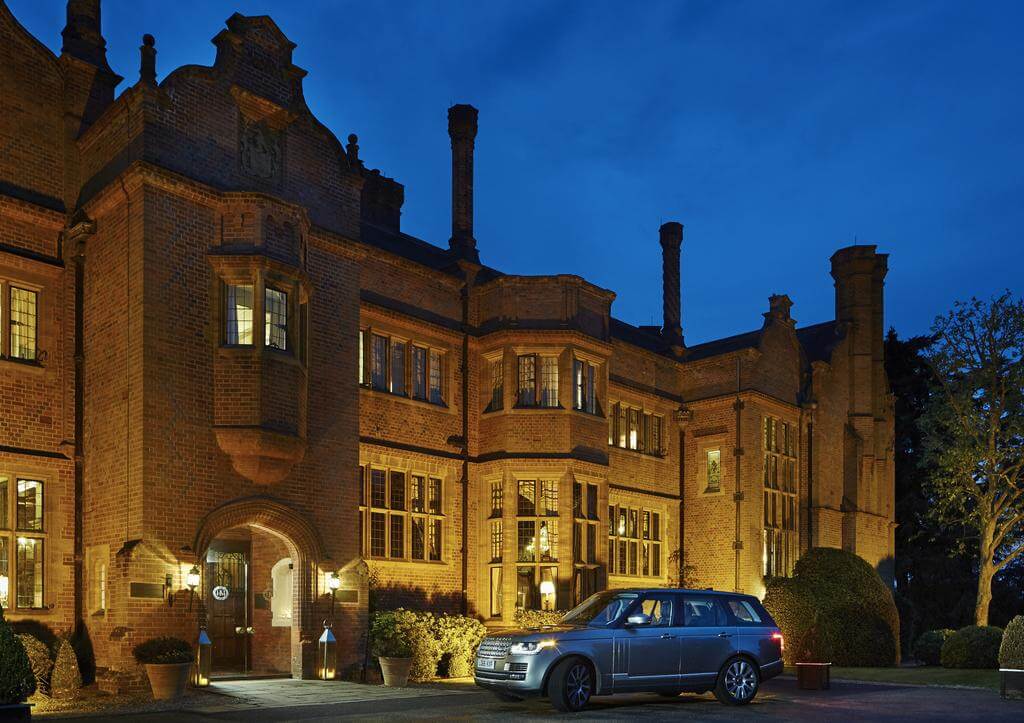 Exterior view of the entrance at Hanbury Manor Golf Marriott Hotel And Country Club in the evening