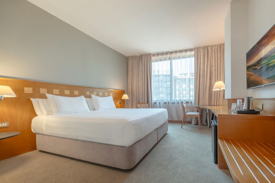 Bedroom with double bed and window at Hotel Carlemany Girona in Costa Brava, Spain