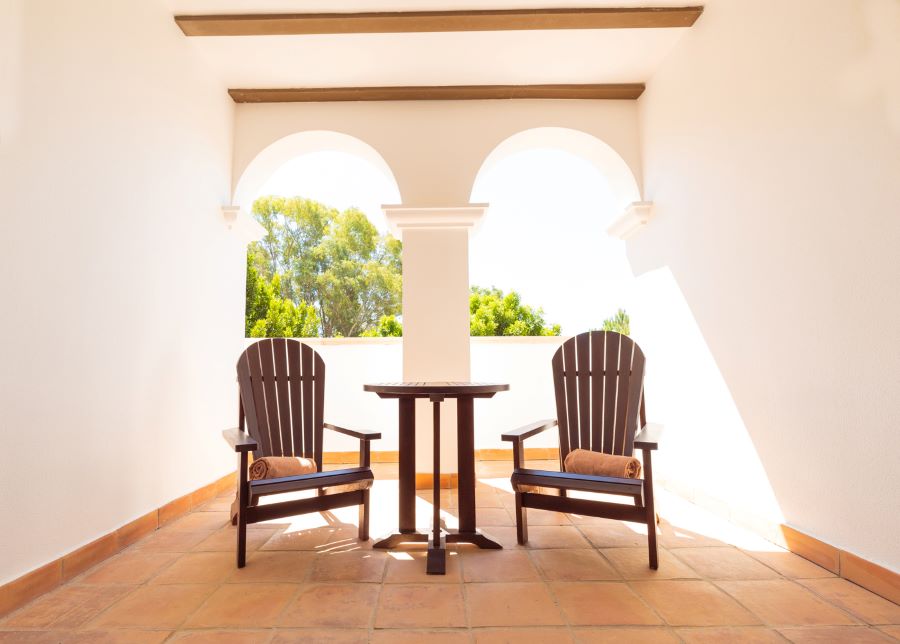 Terrace area with table and two chairs at Hotel Isla Canela Golf Resort in Costa De La Luz, Spain