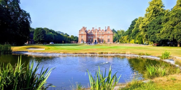 Pond on the golf course with Broome Park Hotel in the distance