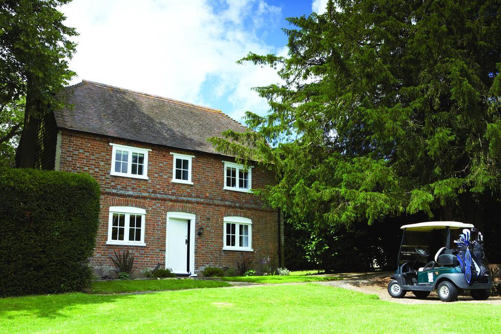 Golf buggy parked outside cottage at Mannings Heath Golf & Wine Estate