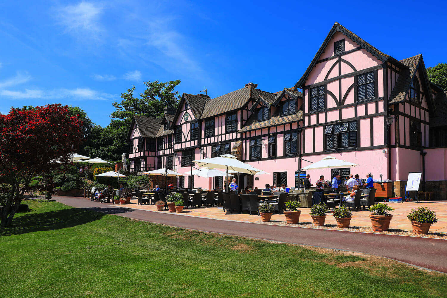 External view Mannings Heath Golf & Wine Estate with guests enjoying drinks on the patio