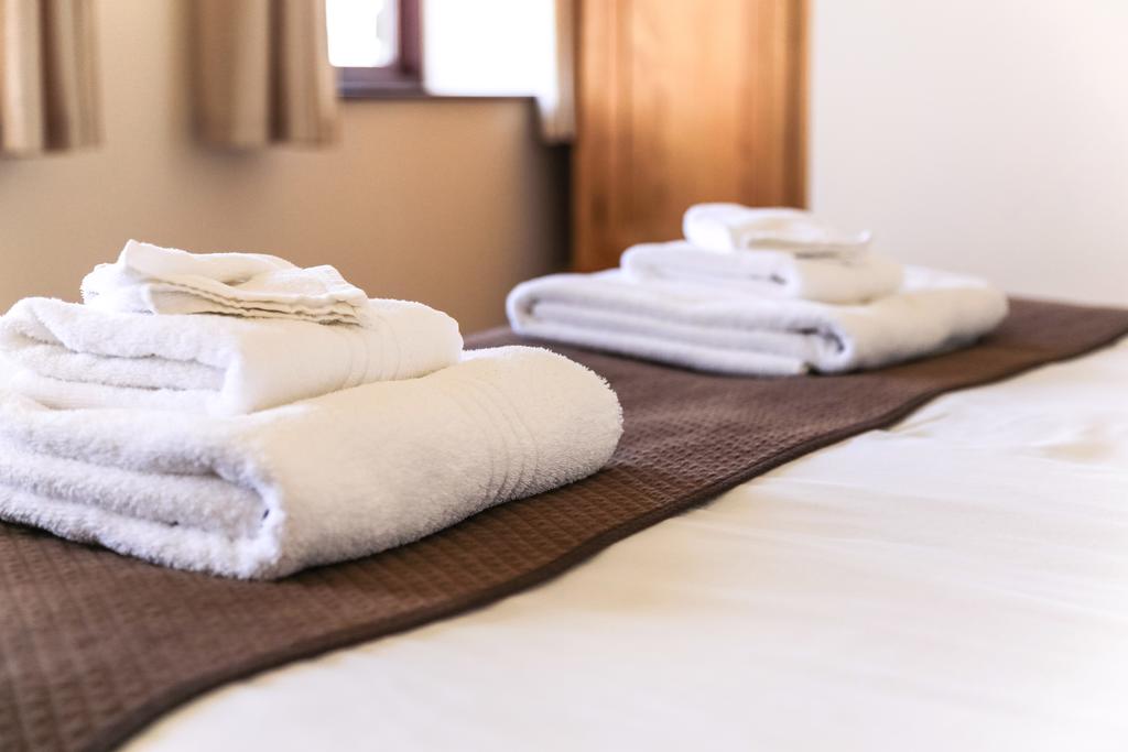Towels on bed at Bowood Park Hotel