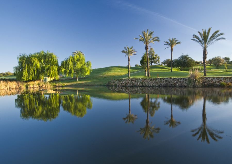 Pestana Gramacho Golf Course in the Algarve with lake and palm trees