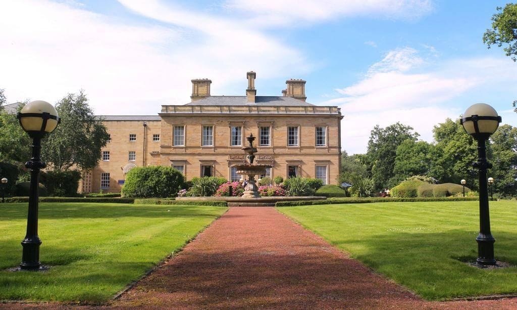 A front few of Oulton Hall on a sunny day