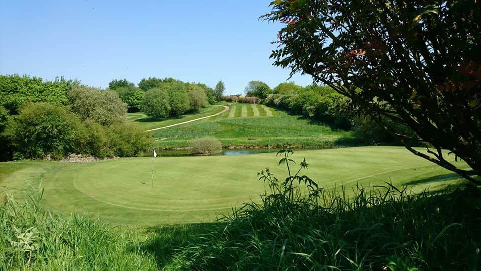 A green on a hole on the golf course at Cotswolds Hotel Spa And Golf