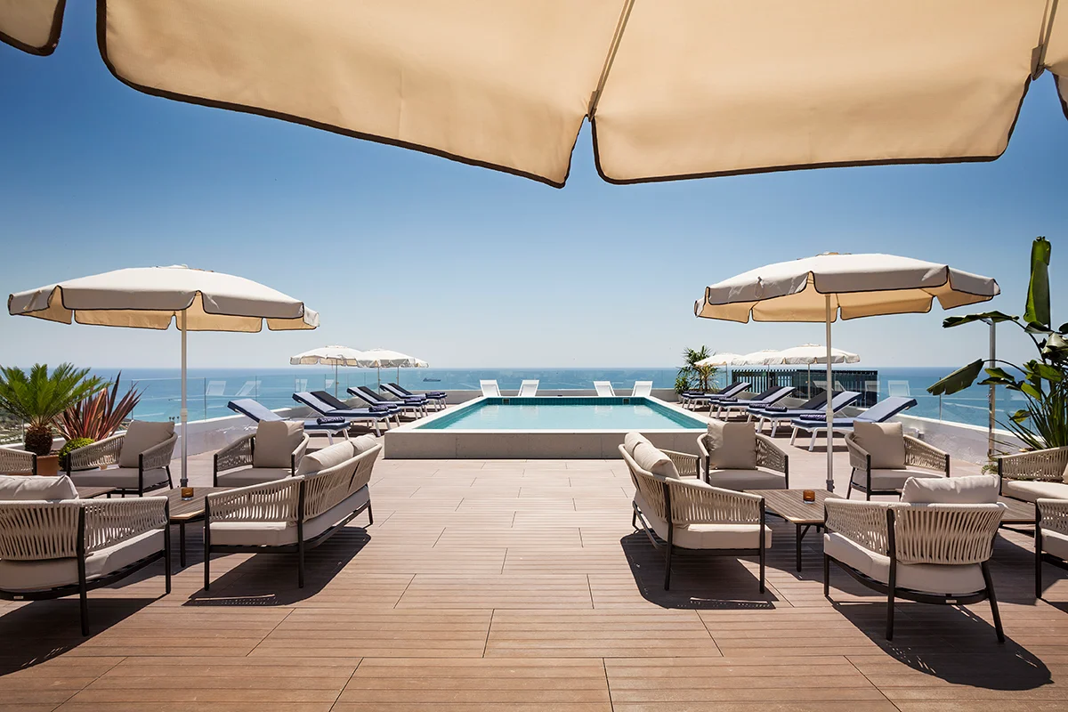 an outdoor pool on a sunny day at H10 Imperical Tarraco