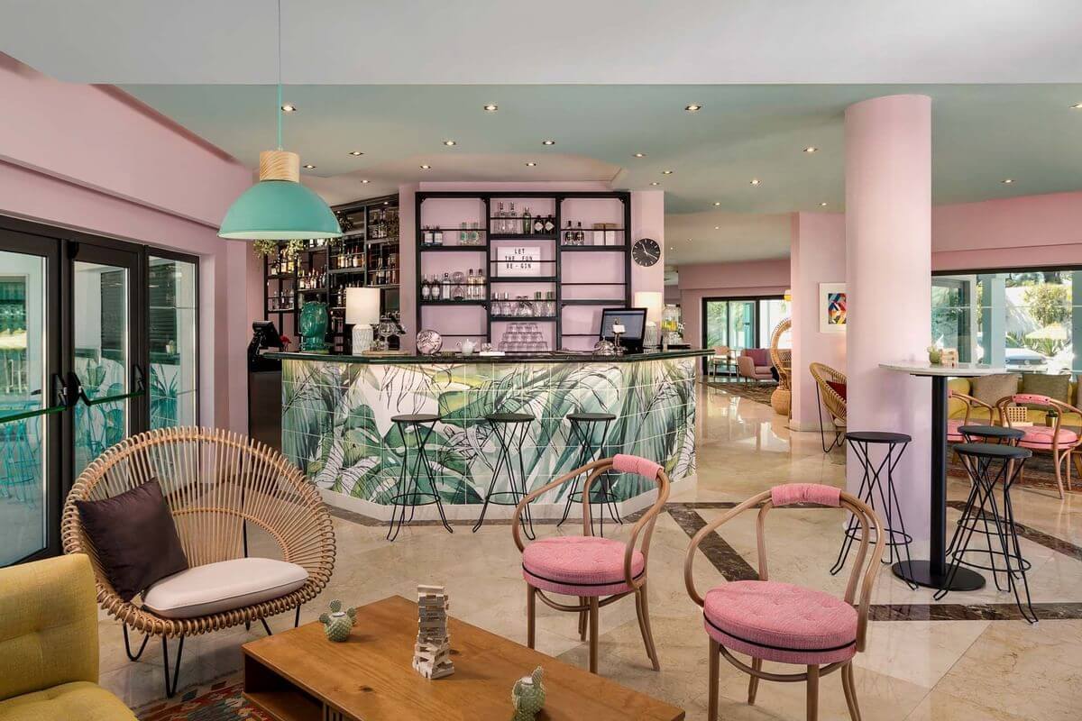 Bar at The Magnolia hotel with pink chairs, and plant themed decoration