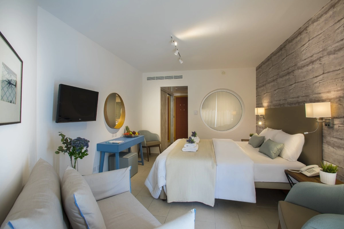 Leonardo Plaza Cypria Maris Beach Hotel & Spa in standard room with television on the wall, sofa and private bathroom