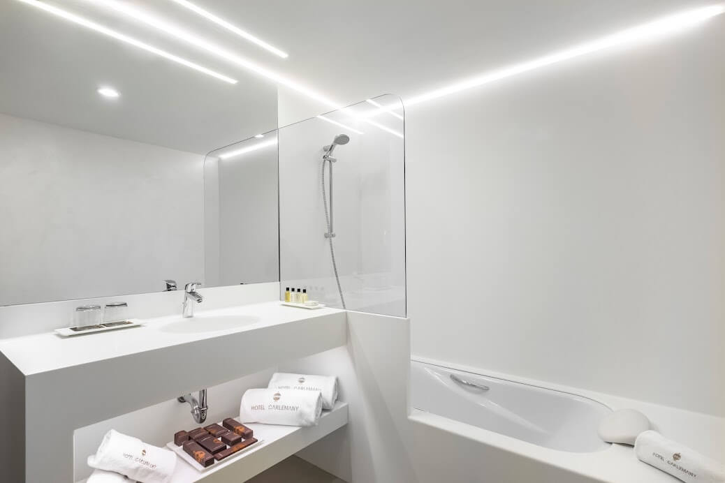 Bathroom with shower, bath tub and sink at Hotel Carlemany Girona