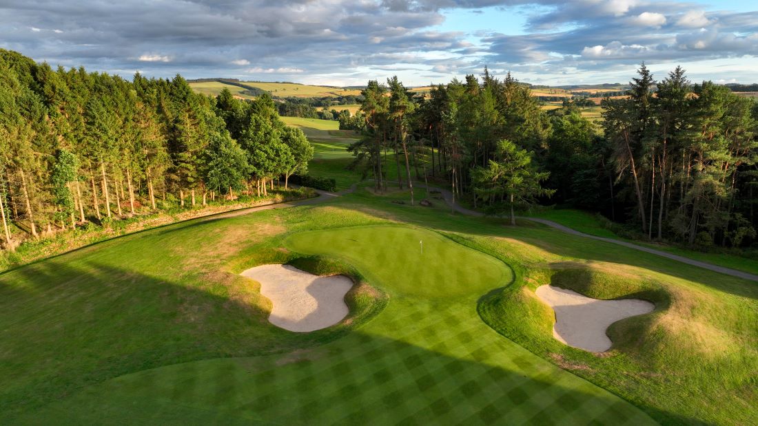 Roxburghe Golf Course with green protected by two bunkers, surrounded by trees