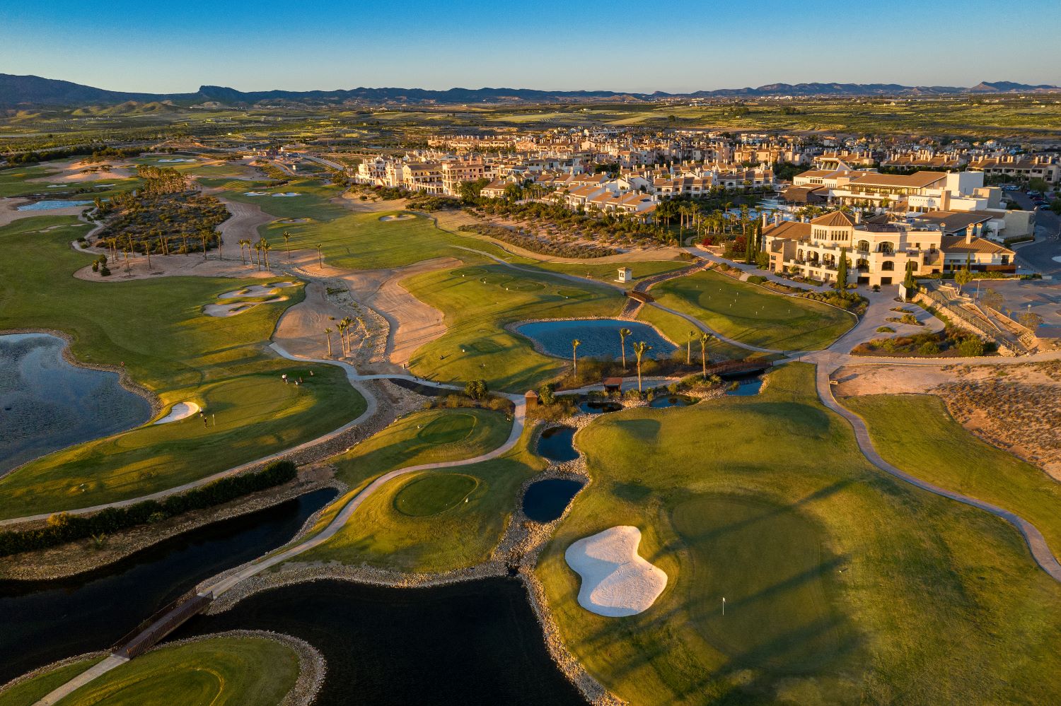 Hacienda Del Alamo golf course from the air with lake, bunker and putting green