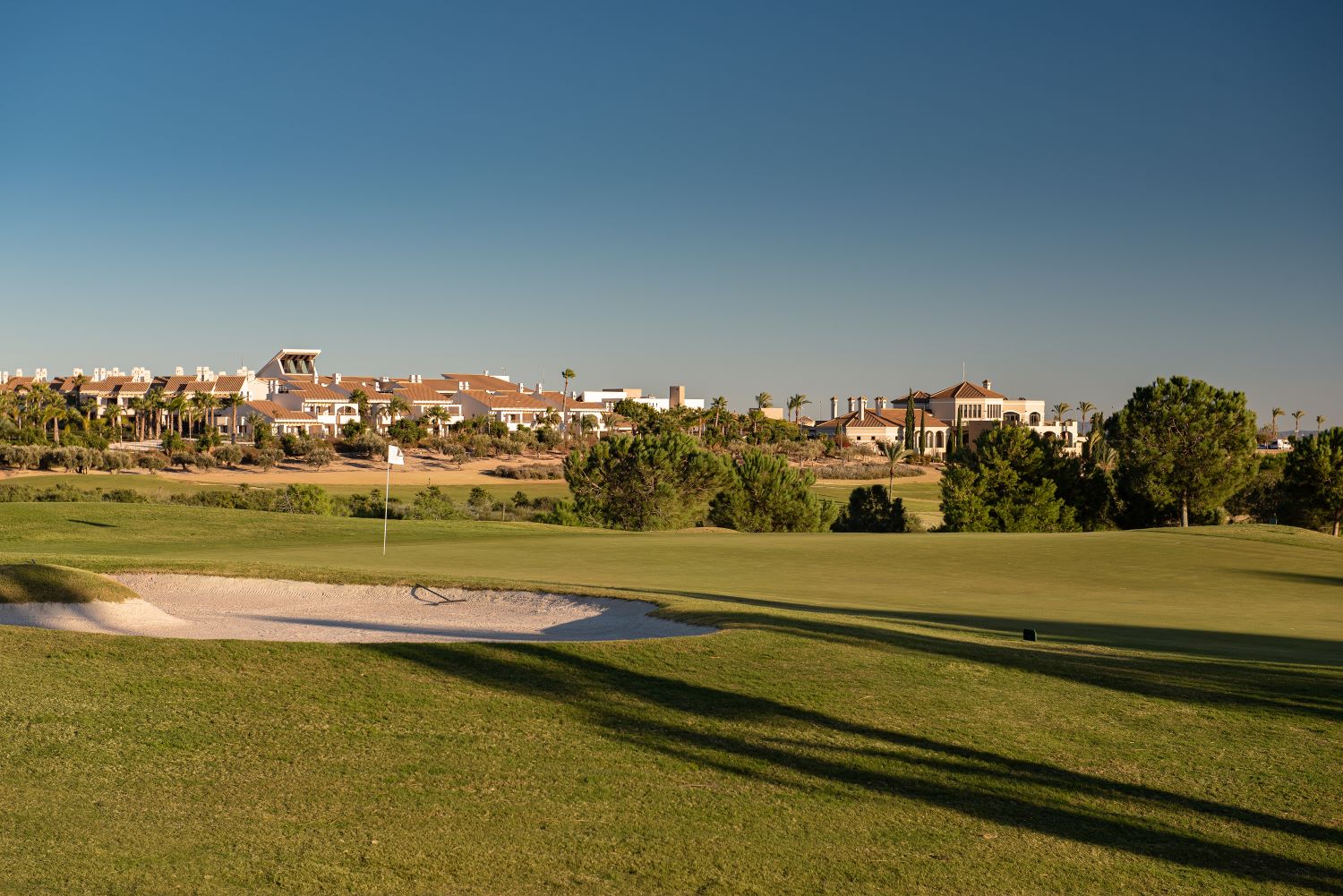 Bunker on the fairway with hotel in the distance at Hacienda Del Alamo golf course