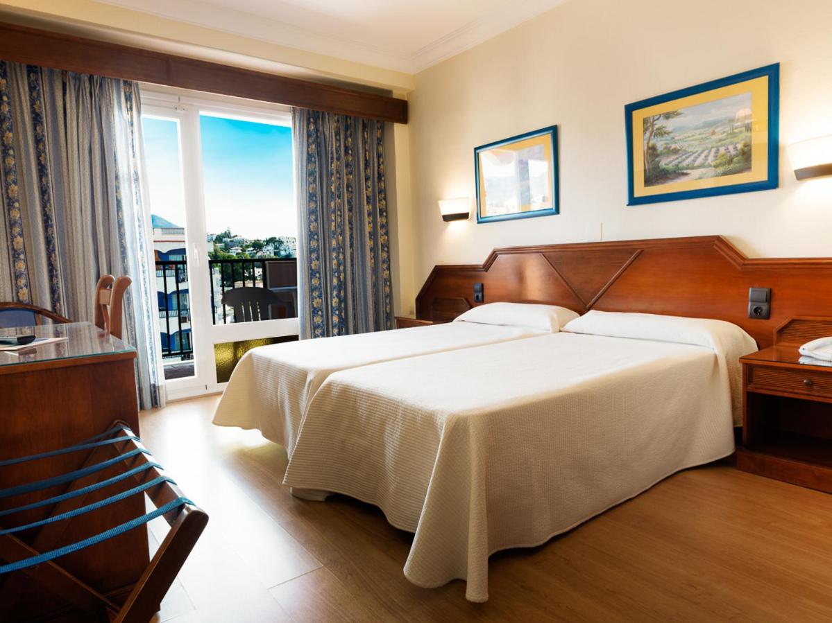 Bedroom with balcony at Hotel Monarque Fuengirola Park in Costa Del Sol, Spain