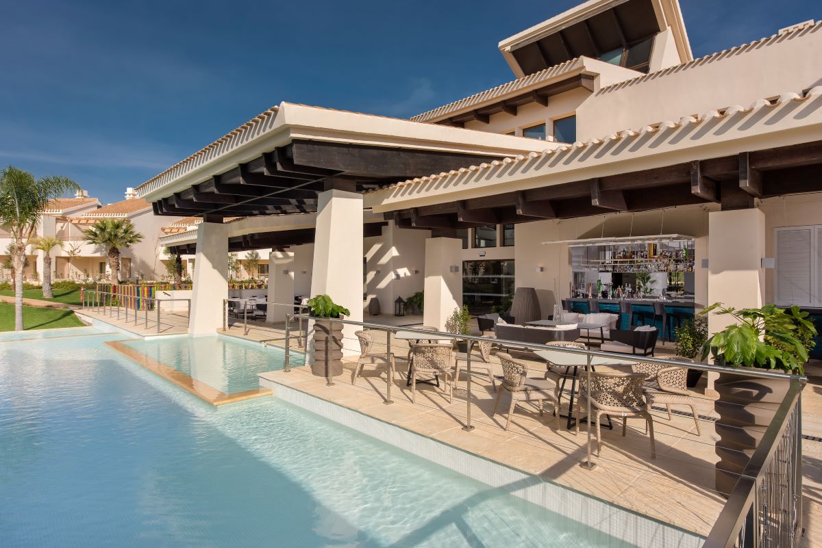 Outdoor café by swimming pool at Hacienda Del Alamo Golf Resort