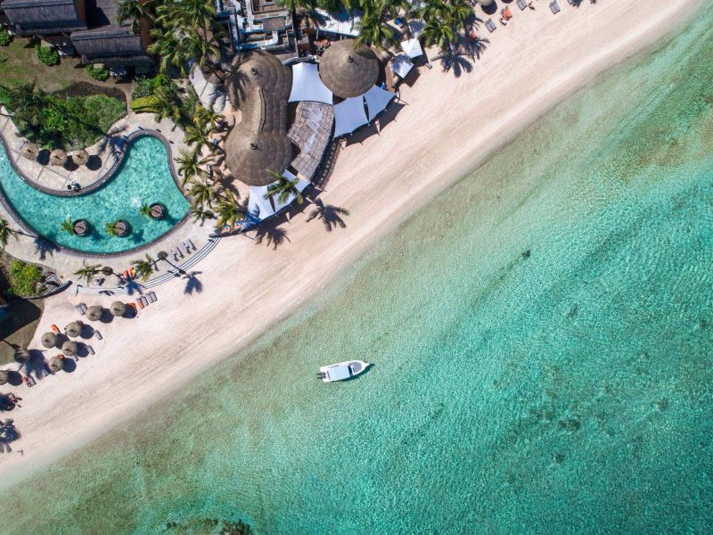 Boat by the cystal clear blue sea at Heritage Awali Golf & Spa Resort in Mauritius