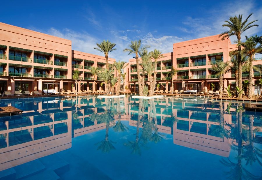 Outdoor swimming pool with palm trees at Pickalbatros Hotel Du Golf Palmeraie Marrakech
